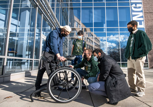 Mechanical engineering students design a motorized basket for a wheelchair for their senior design project.