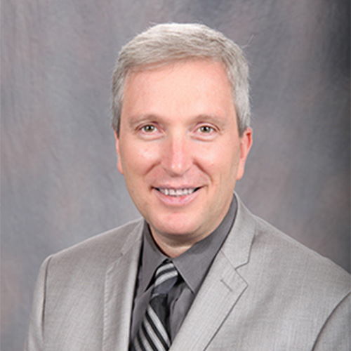 Professor Alex Sprintson in a gray suit and shirt and black tie