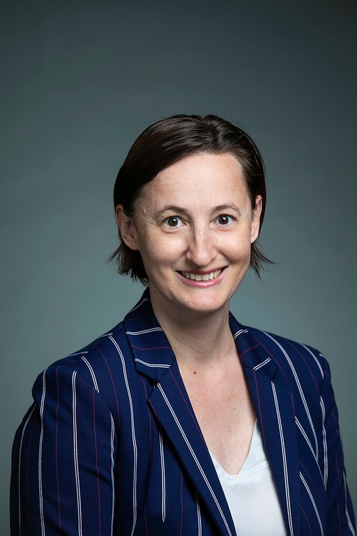 Leigh McCue wears a striped blue suit and light blouse in her faculty profile for the Department of Mechanical Engineering