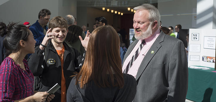 Dr. Kenneth Ball, dean of the Volgenau School of Engineering, speaks with George Mason students.