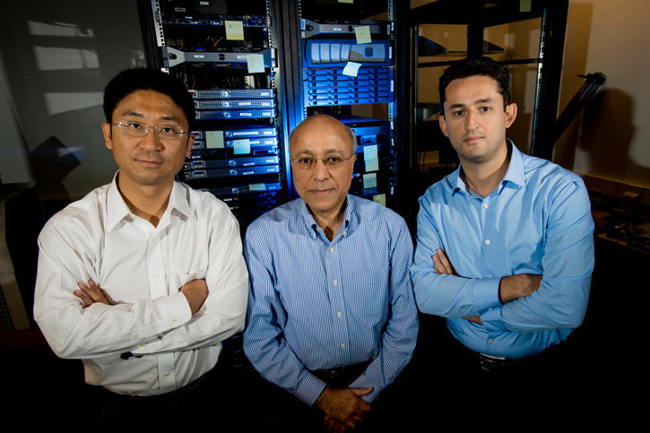 Three professors in a computer lab.