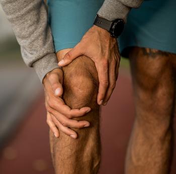 hands holding a knee