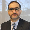 Mehdi Darehbidi wears a dark suit, striped tie, and glasses in his faculty profile for the Department of Mechanical Engineering