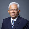 GMU professor Nathan Kathir in a dark blue suit and tie